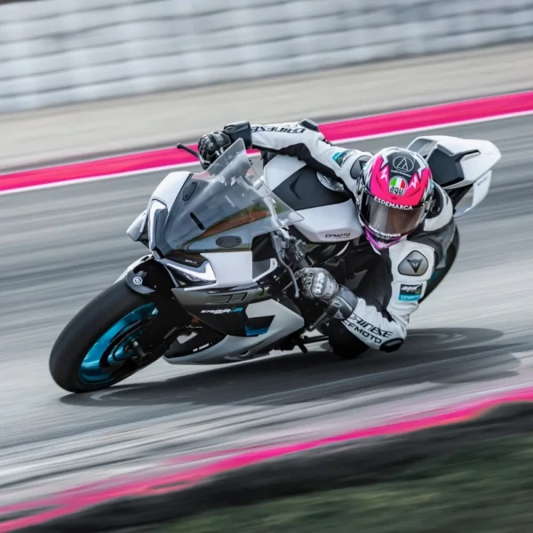 0208_YM24_CFMoto_675SR-R_v3_2 A motorcyclist in full gear leans into a turn on a race track during a track day, riding a white and blue racing motorcycle.