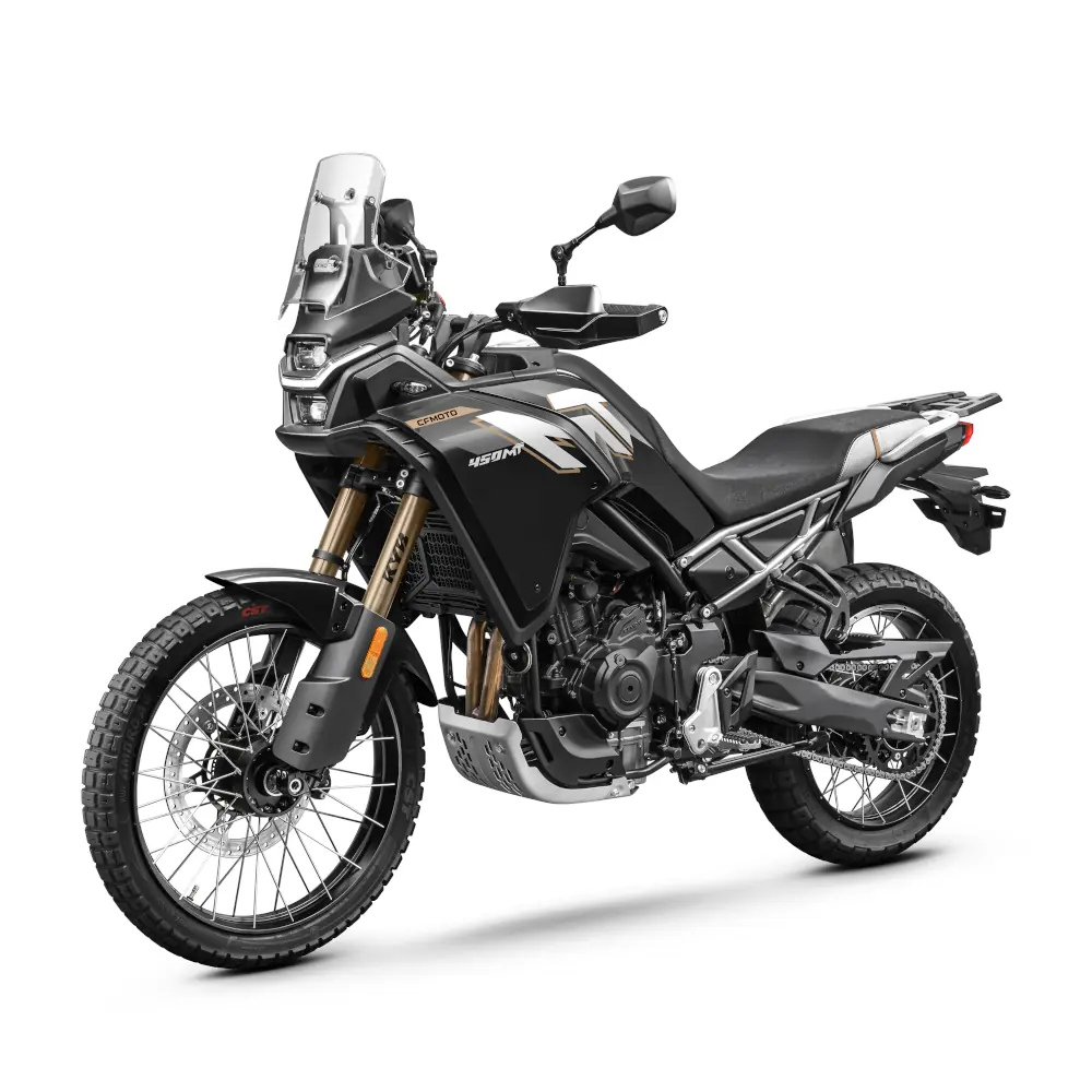 A black and gold adventure motorcycle from CFMoto Motorcycles, featuring off-road tires, a tall windshield, and upright handlebars, viewed from a three-quarter angle on a white background.