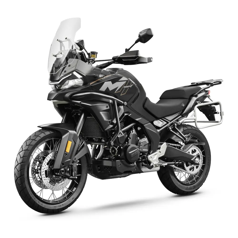 Black CFMoto adventure motorcycle with high front windshield, spoked wheels, and side luggage rack, shown on a white background at a three-quarter front angle.