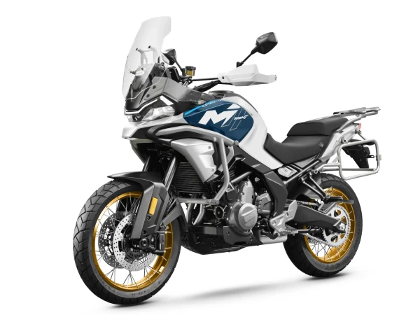 A modern 700MT adventure motorcycle with gold spoked wheels, a blue and white body, tall windscreen, and rear luggage rack is shown on a white background.
