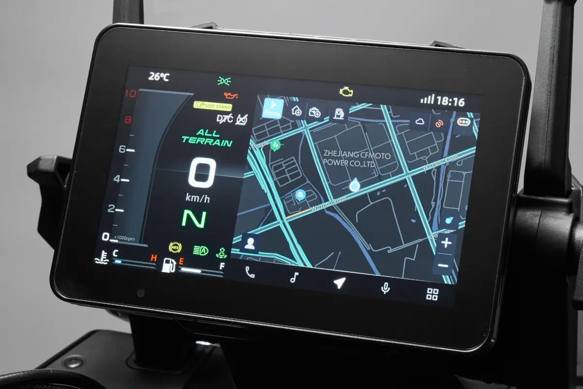 Close-up of a digital vehicle dashboard featuring the CFMOTO T-Box, displaying speed, temperature, and a navigation map with street details and a highlighted location.