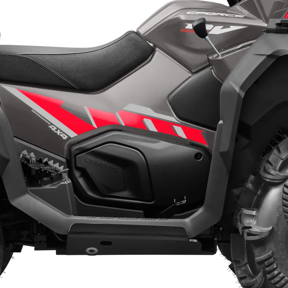 Close-up side view of a gray and red CFORCE 1000 MV all-terrain vehicle (ATV), focusing on the seat, body, and rear tire.