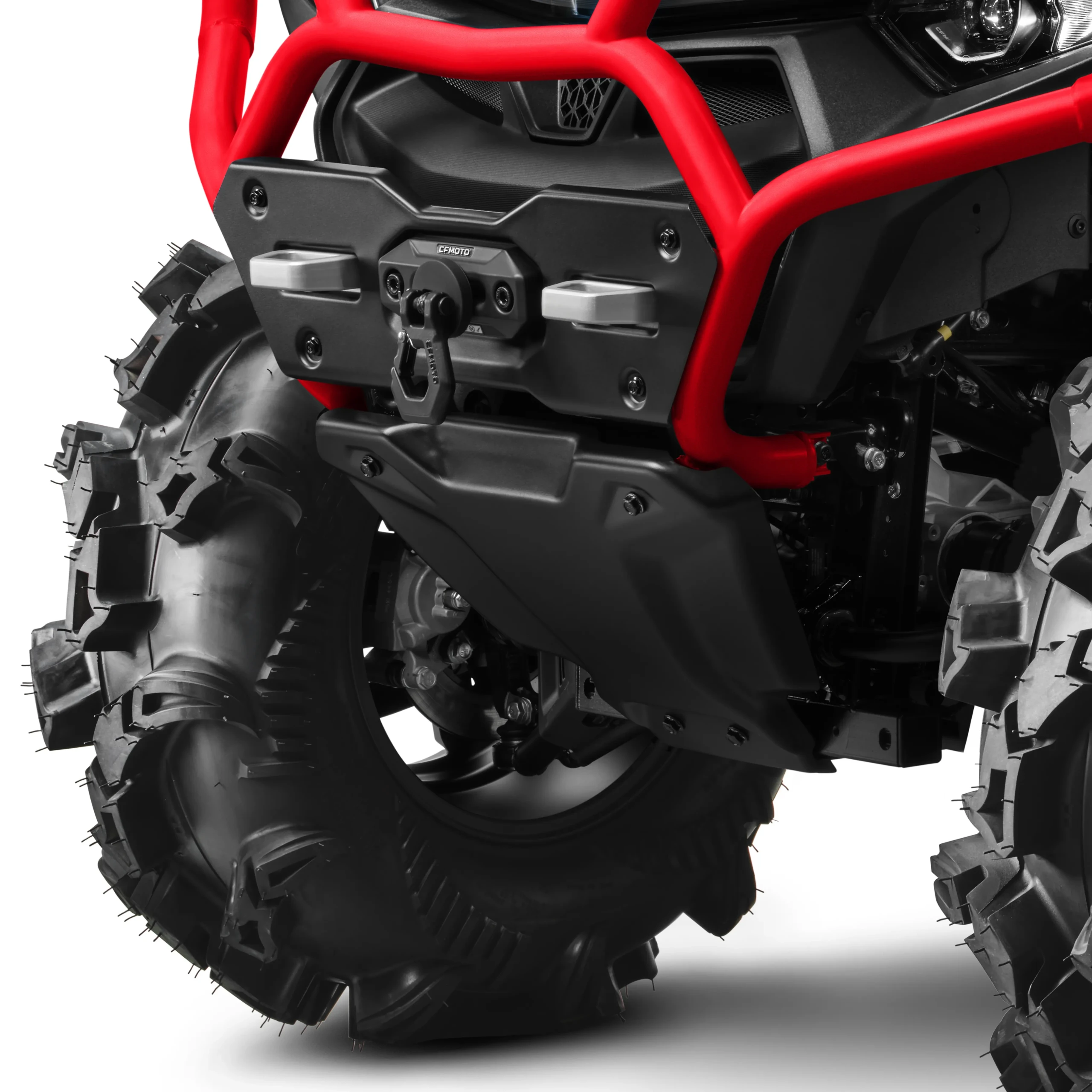 Close-up view of the front left wheel and suspension of a CFORCE 1000 MV off-road vehicle, featuring thick, deep-tread tires and a red protective bumper.